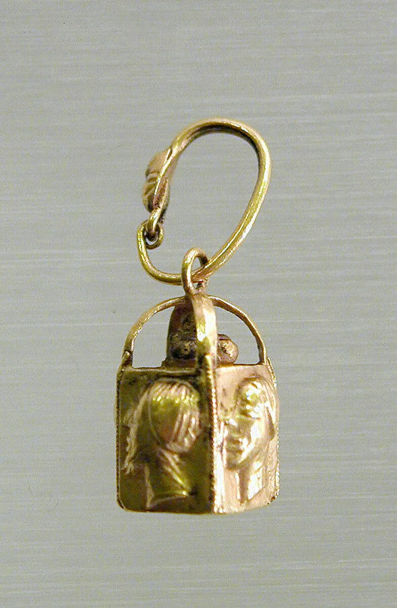 Pair of gold earrings with four relief faces — Unknown