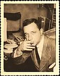 [Walker Evans Seated at Desk Holding Pencil]