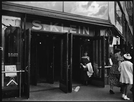 [Woman in Doorway of S. Klein-on-the-Square Department Store, Union Square East, New York City]