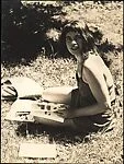 [Unidentified Woman Seated on Grass with Books]