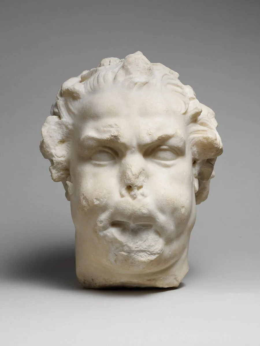 Marble head of a satyr playing the double flute — Unknown