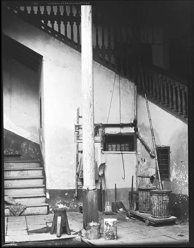 [Courtyard with Brooms, Trashcans, and Rear Stairwell, Havana]
