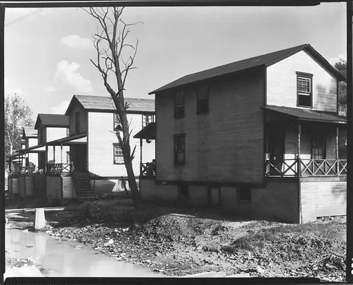 [Row of Clapboard "Company" Houses for Miners Along Creek, Osage, West Virginia]