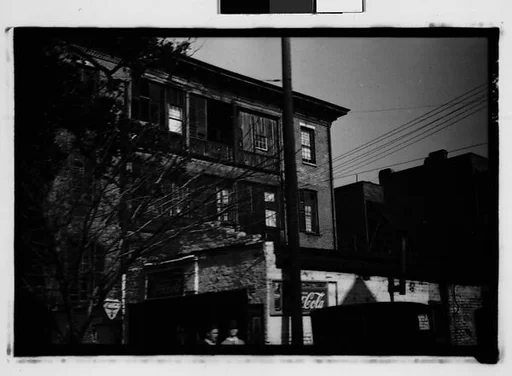 [Italianate Town House Behind Brick Building with Coca-Cola Signs, From Automobile, Savannah, Georgia]