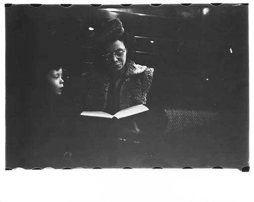 [Five 35mm Film Frames: Subway Passengers, New York City: Mother and Son with Book]