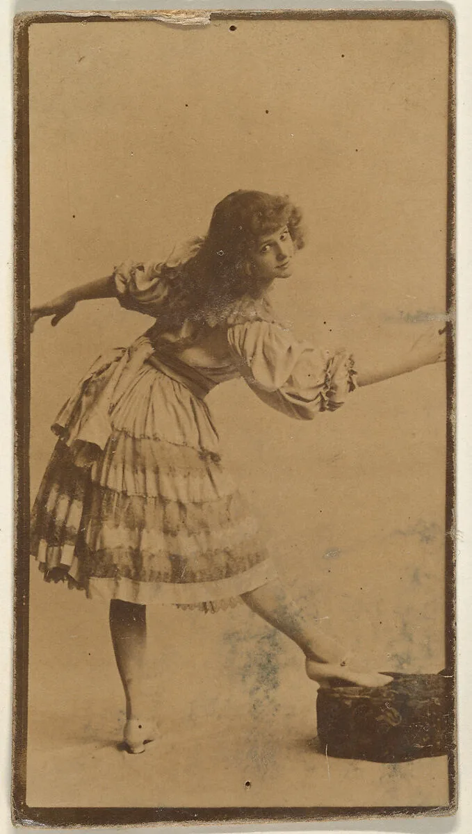 Actress posing with foot on cushion, from the Actresses series (N668) — Unknown