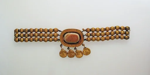 Necklace with gold beads and pendants attached to agate in box setting