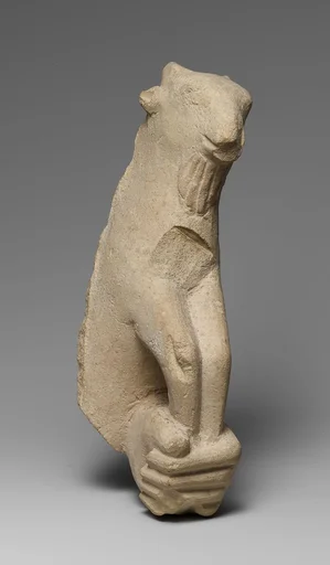 Limestone statue fragment of a left hand holding a kid