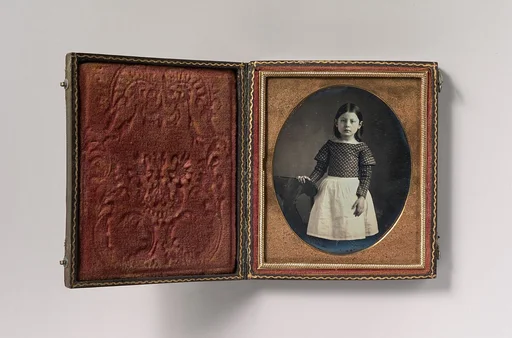 [Young Girl Wearing Waist Apron, Resting Hand on Chair]