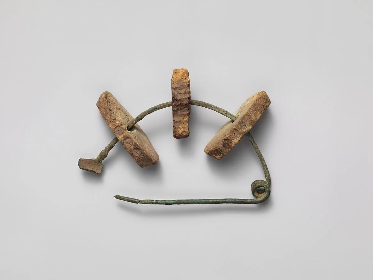 Bronze fibula (safety pin) with amber segments — Unknown