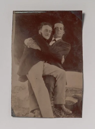 [Two Men Embracing, One Seated in the Other's Lap]