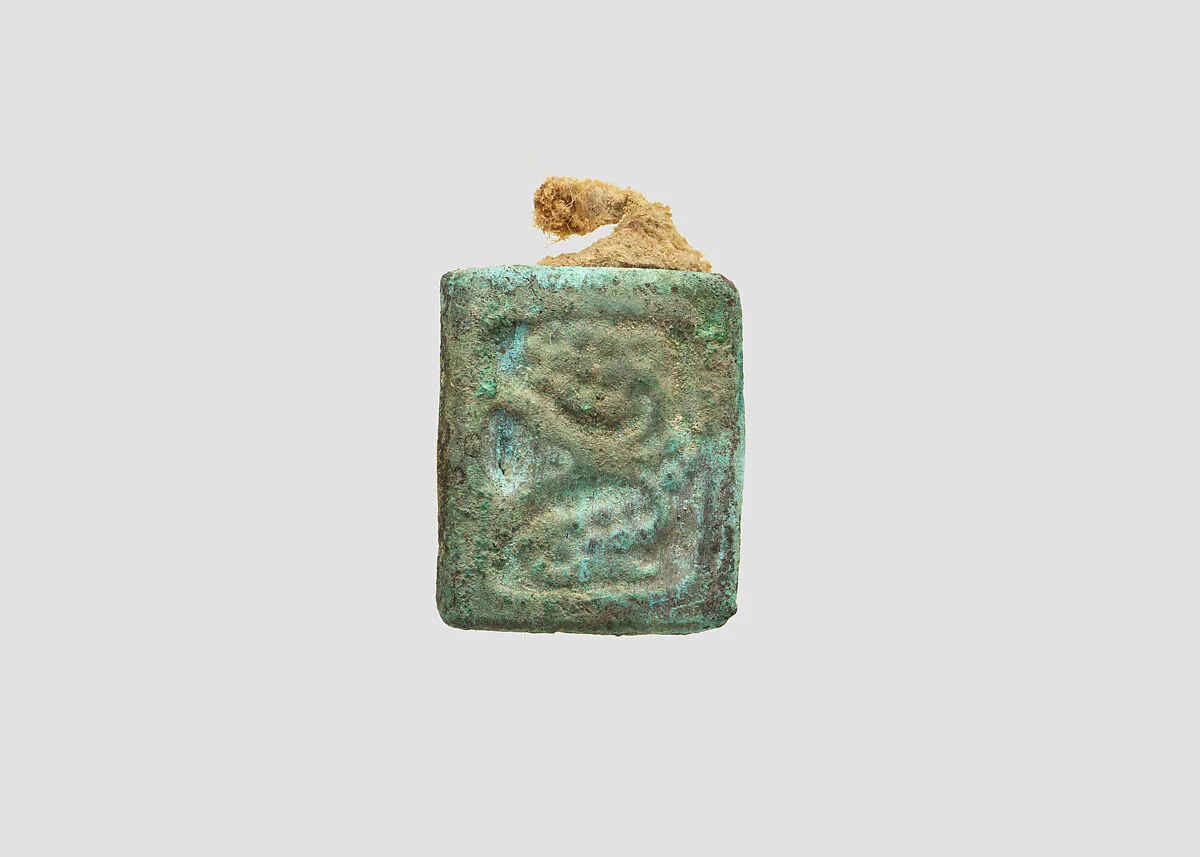 Bronze belt plaque with attached fragment of leather belt — Unknown