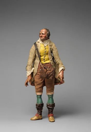 Gentleman with yellow vest, tan/maroon knickers, beige coat, falling down stockings over blue legs, and shoulder bag