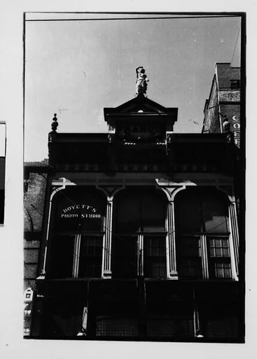 [One 35mm Film Frame: Greek Revival Building (Boyett's Photo Studio) with Figurehead Above Pediment]