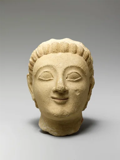 Limestone head of a beardless man