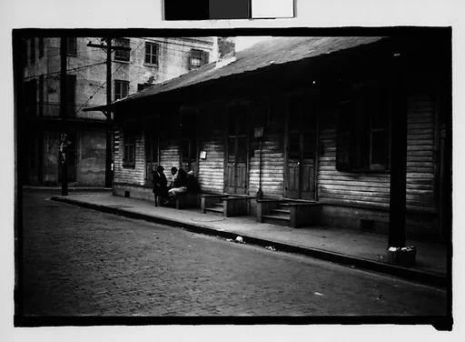 [Group Seated on Stoop in French Quarter, New Orleans, Louisiana]