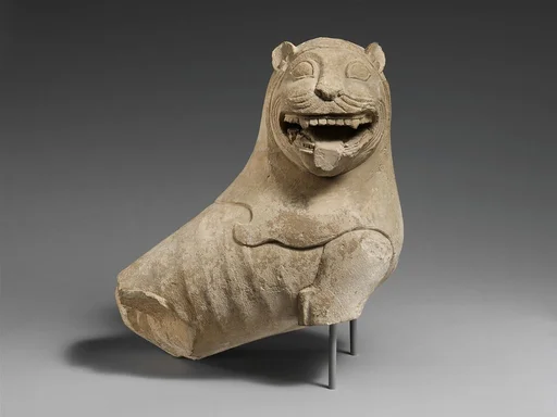 Limestone finial of a funerary stele with a seated lion