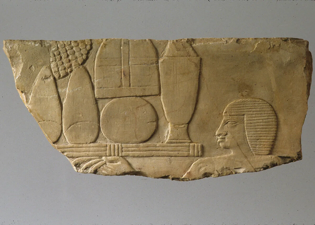Relief with head of an offering bearer and offerings — Unknown