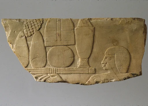 Relief with head of an offering bearer and offerings