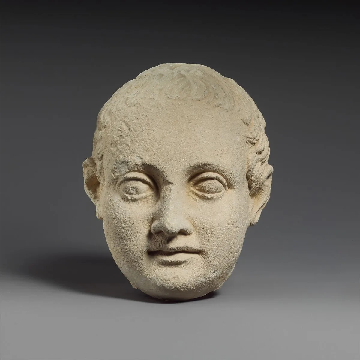 Limestone head of a boy — Unknown