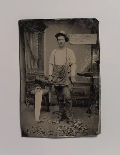 [Carpenter or Cabinetmaker Standing Before a Sign Advertising His Trade]