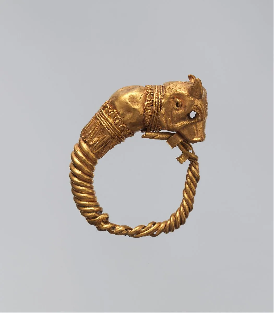 Earring with bull's head whose eyes were previously inlaid — Unknown