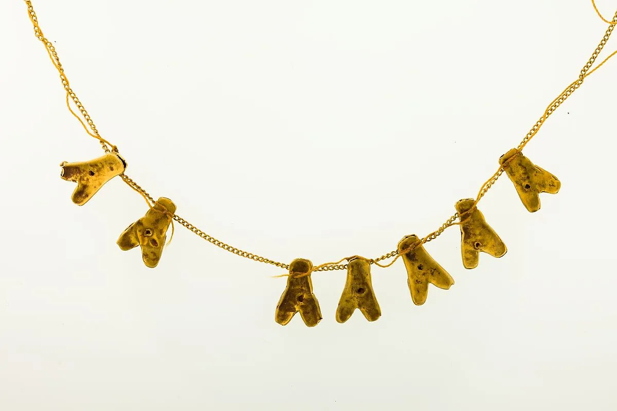 String of 7 fly amulets — Unknown