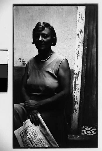 [Woman with Newspaper Seated in Courtyard, Havana]
