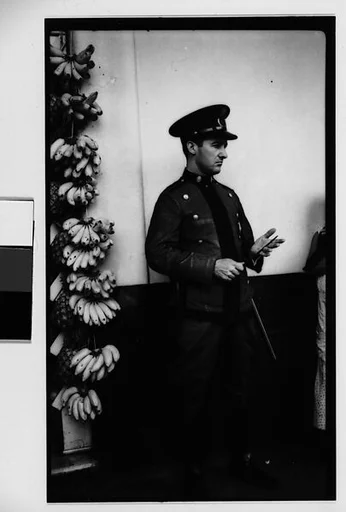 [Policeman in Front of Fruit Stand on Street, Havana]
