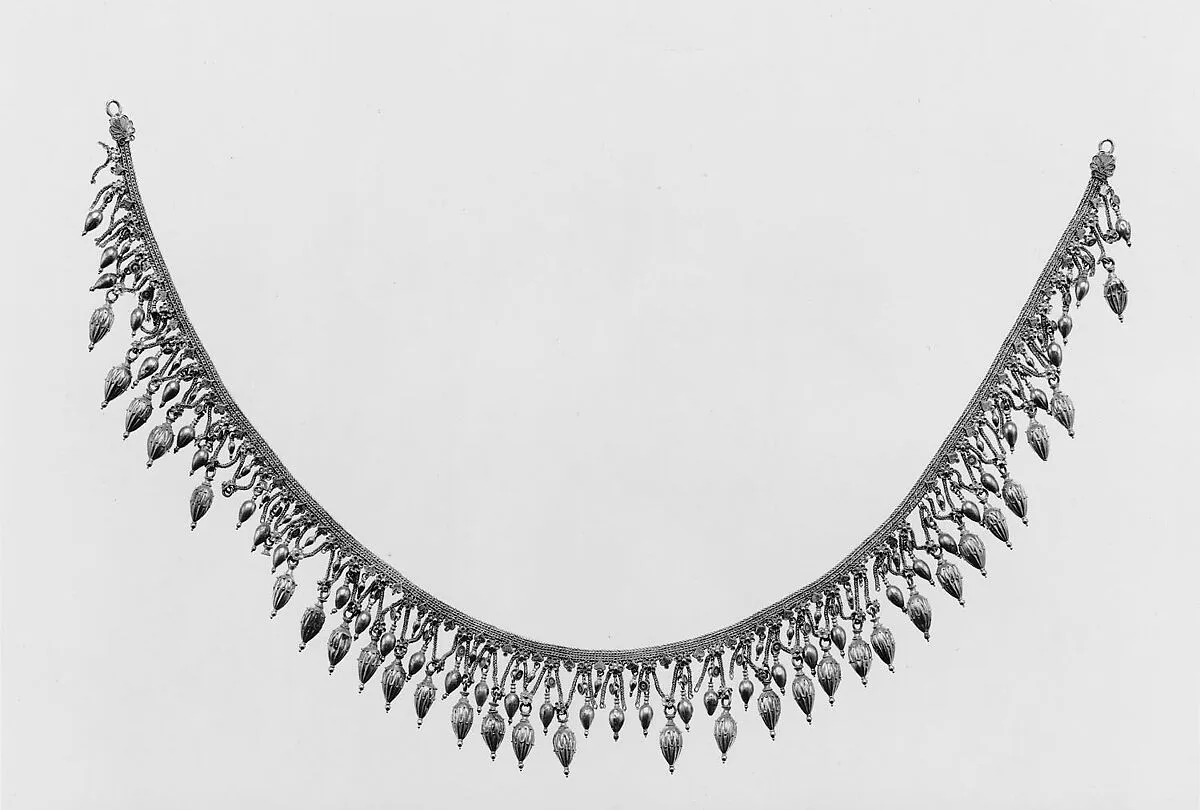 Gold strap necklace with seedlike pendants — Unknown