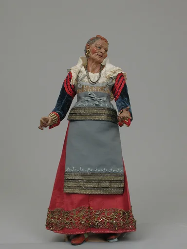 Old woman carrying a wire basket