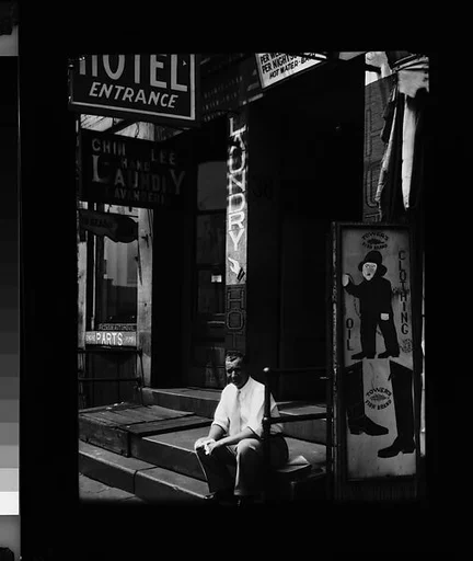[Flophouse Entrance on the Bowery with Man Seated on Stoop, New York City]