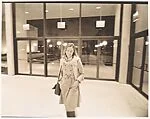 [Young Woman, Possibly Susan Thornton, Standing Before Glass Doors]