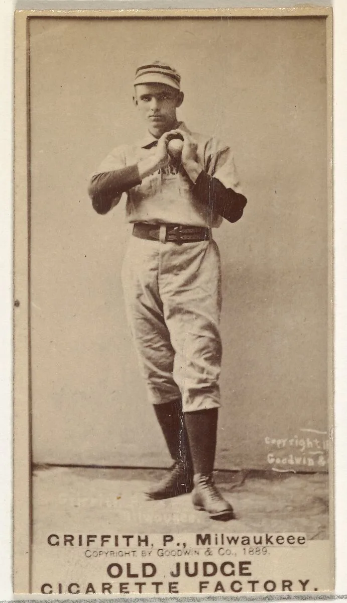 Clark Calvin "Old Fox" Griffith, Pitcher, Milwaukee, from the Old Judge series (N172) for Old Judge Cigarettes — Goodwin & Company