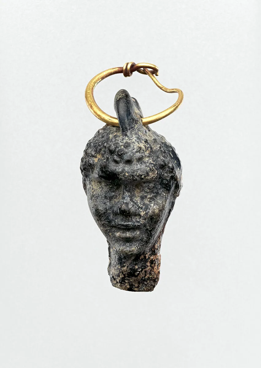 Gold earring with a glass pendant in the shape of a Black African’s head — Unknown