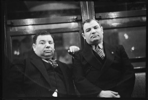[Five 35mm Film Frames: Subway Passengers, New York City: Two Men in Suits]