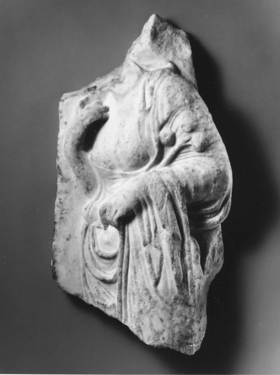 Marble relief fragment with the torso of a Hesperid holding apples — Unknown