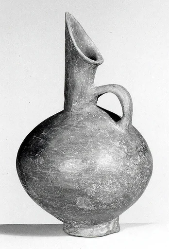 Spouted jug with a mottled surface