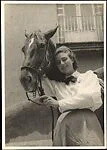 [Woman with Horse Standing Before Balcony]