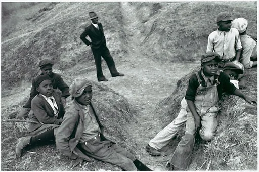 [Group of Young Boys and Dark Suited Man on Levee, Vicinity New Orleans, Louisiana]