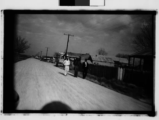 [Men Walking by Side of Road, From Moving Automobile, New Orleans Vicinity, Louisiana]