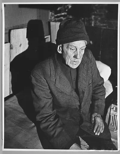 [Seated Man Wearing Cap, for Fortune Magazine Article "People and Places in Trouble"]