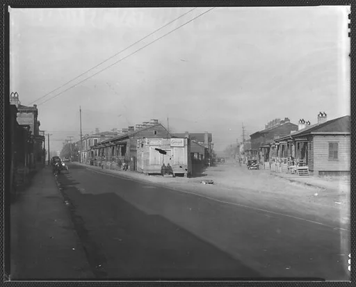 [Fork in Road with Two Rows of Wooden Houses and People on Corner, Savannah or Augusta, Georgia]