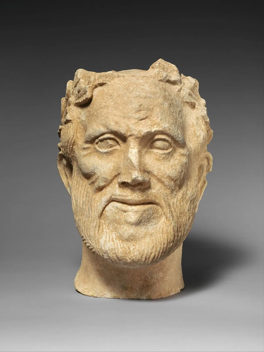 Limestone head of bearded male votary with wreath of leaves — Unknown