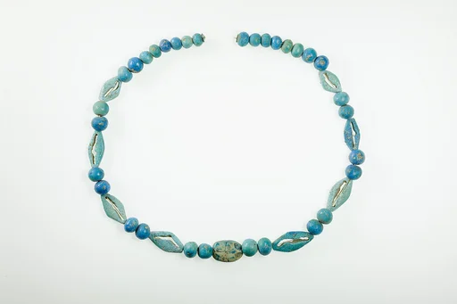 String of  ball beads, cowrie-styled beads, and a scarab