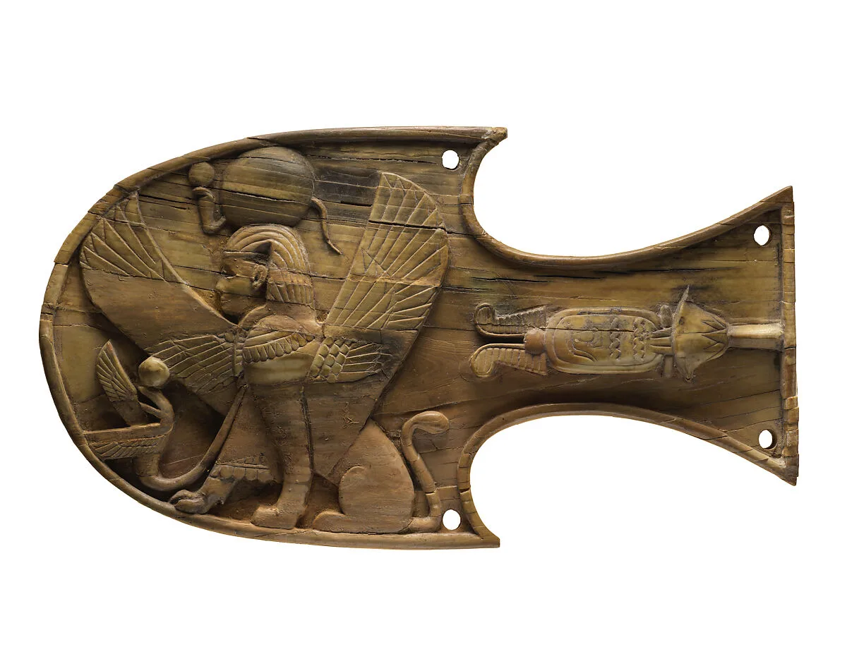 Horse blinker carved in relief with a seated sphinx — Unknown