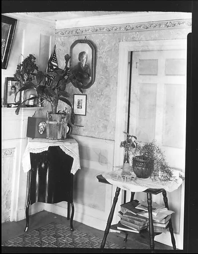 [Interior Showing Cactus Plant and Family Photographs on Mantle and Wall in De Luze House, Truro, Massachusetts]