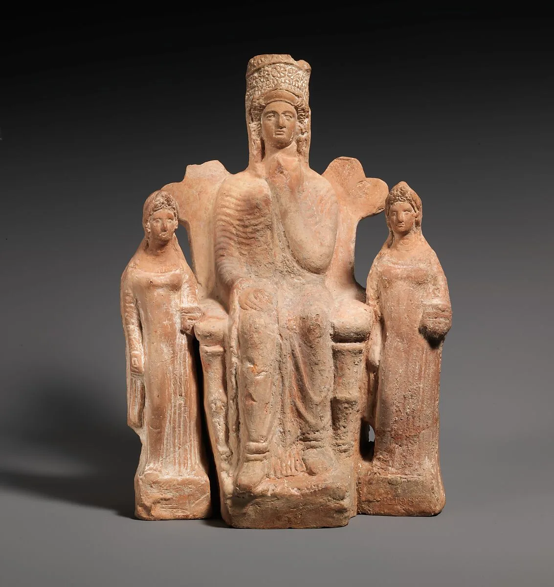 Terracotta statuette of an enthroned goddess between two attendants — Unknown