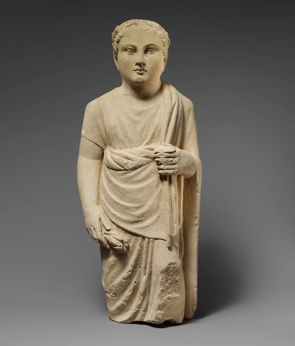 Limestone statuette of a boy holding a pyxis and a branch of leaves — Unknown