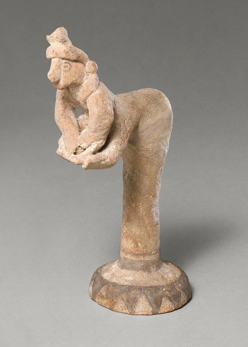 Female figurine kneading dough(?) — Unknown